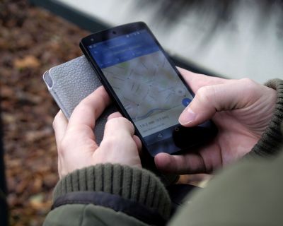 Someone using a cellphone and a map app, cold calls