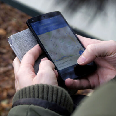 Someone using a cellphone and a map app