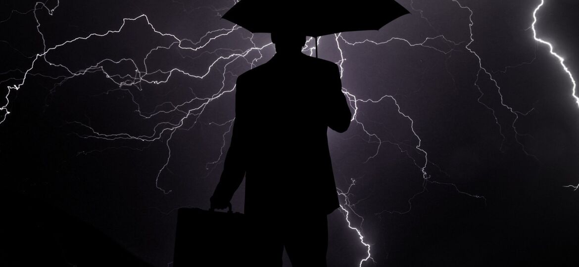 Business man with lightning all around him