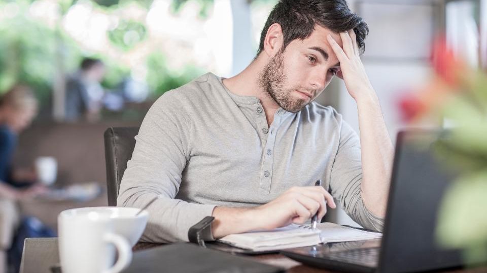 Man feeling stressed while working remotely