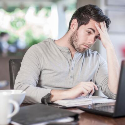 Man feeling stressed while working remotely