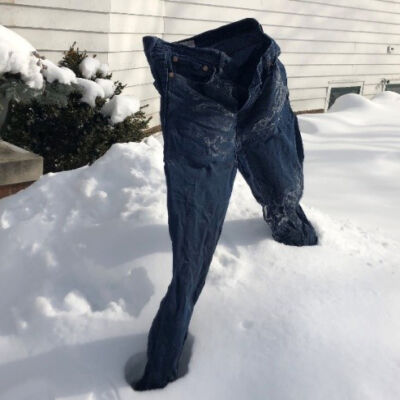 Frozen pants standing up in the snow by themselves