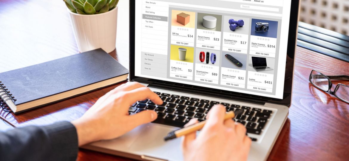 Person working on a laptop displaying an online shop e-commerce website with product listings